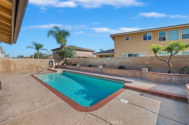 view of pool featuring a patio area, a fenced backyard, and a fenced in pool