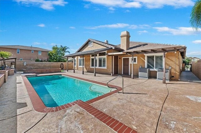 view of swimming pool with central AC, a patio area, fence private yard, and a fenced in pool