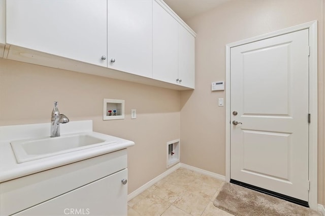 laundry room with cabinet space, baseboards, washer hookup, and a sink