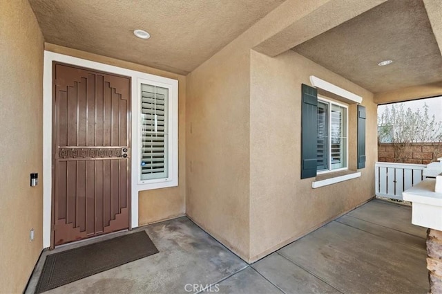 entrance to property featuring stucco siding