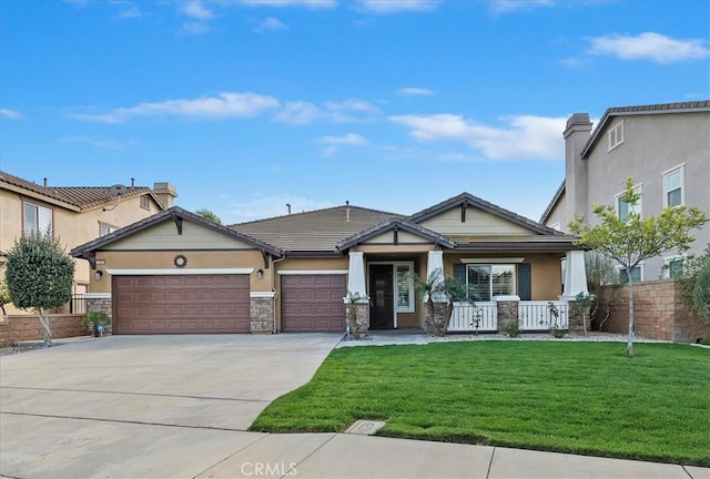 view of front facade featuring concrete driveway, stone siding, an attached garage, covered porch, and a front lawn