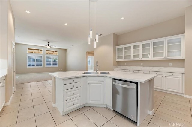 kitchen with glass insert cabinets, open floor plan, white cabinetry, a sink, and dishwasher