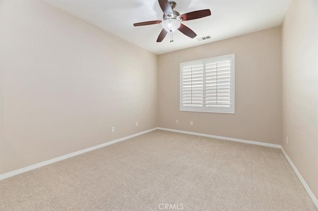 unfurnished room featuring a ceiling fan, visible vents, light carpet, and baseboards