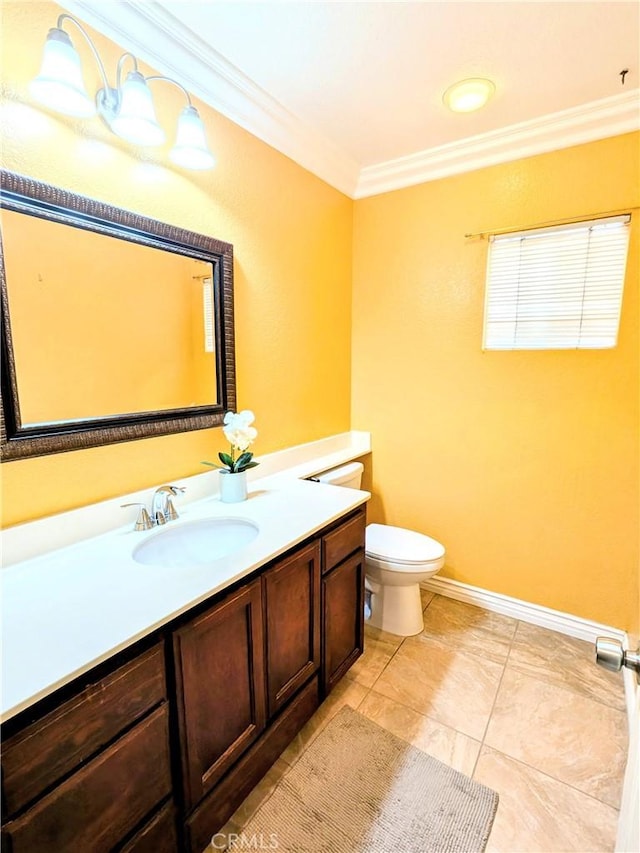 bathroom featuring toilet, baseboards, ornamental molding, and vanity