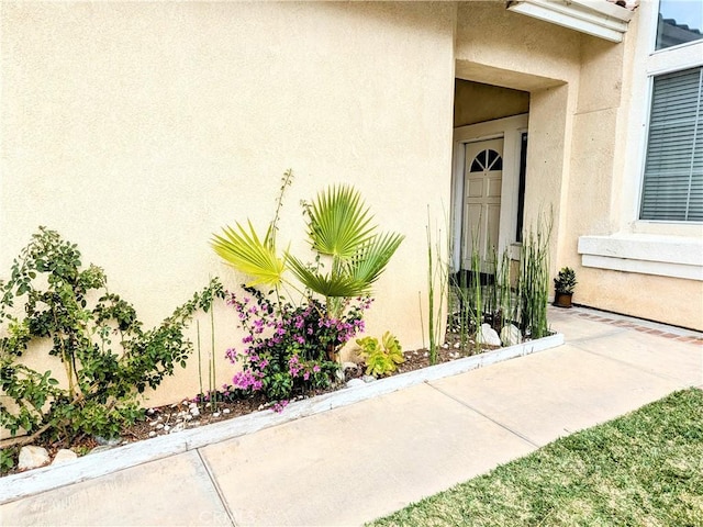 entrance to property with stucco siding