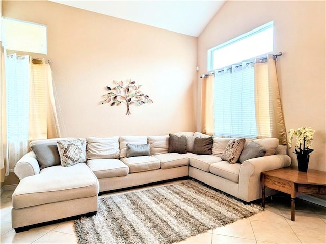 living area featuring lofted ceiling and light tile patterned flooring