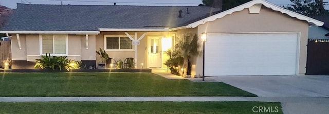 single story home featuring stucco siding, concrete driveway, a garage, and a front yard