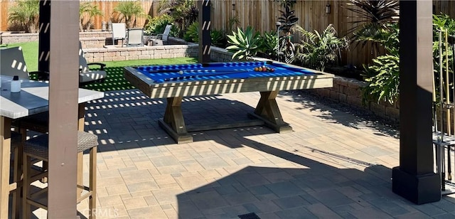 view of patio featuring a fenced backyard and an outdoor fire pit