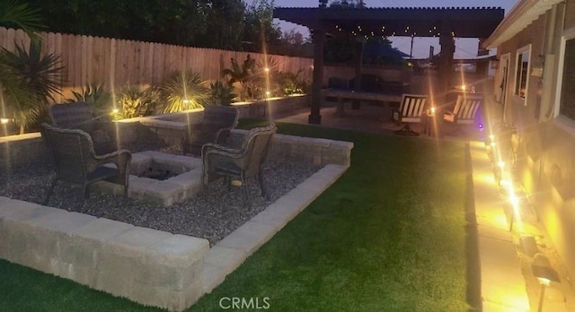 view of yard featuring a patio area, a fire pit, and a fenced backyard