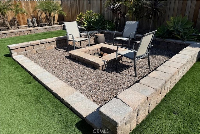 view of yard featuring a patio area, fence, and an outdoor fire pit