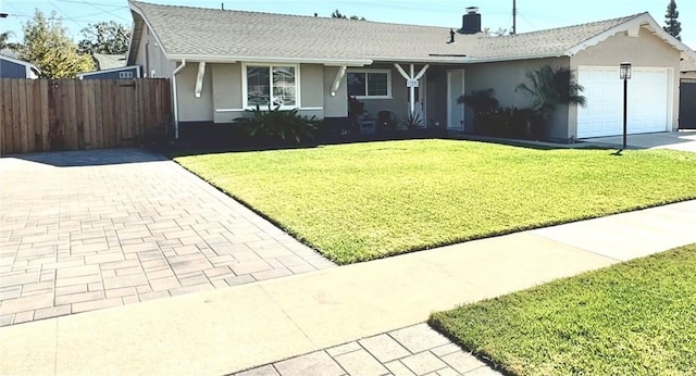 single story home featuring a front yard, stucco siding, a chimney, decorative driveway, and a garage