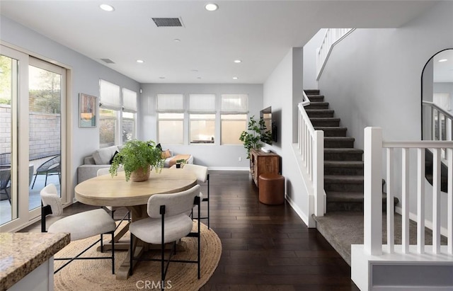 dining area featuring visible vents, dark wood-type flooring, recessed lighting, baseboards, and stairs