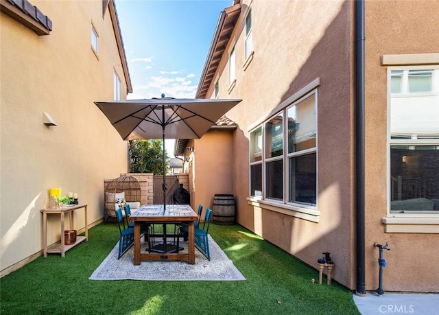 view of patio featuring outdoor dining space and fence