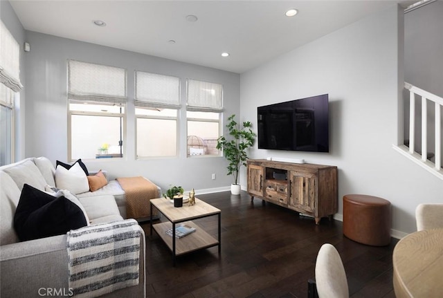 living room with recessed lighting, baseboards, and dark wood-type flooring