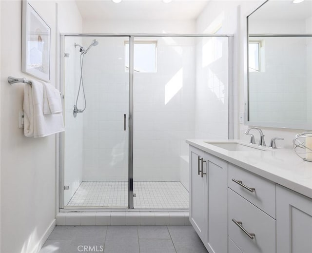 full bath with tile patterned floors, a stall shower, and vanity