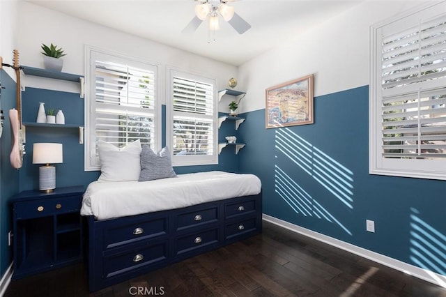 bedroom featuring a ceiling fan, dark wood-type flooring, and baseboards