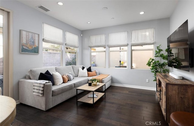 living area featuring recessed lighting, visible vents, baseboards, and dark wood finished floors