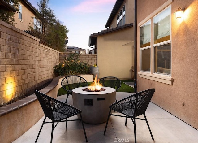 view of patio / terrace with a fire pit and fence