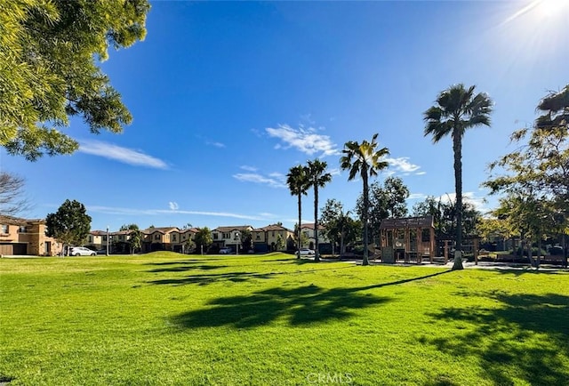 view of home's community featuring a residential view, a lawn, and a pergola