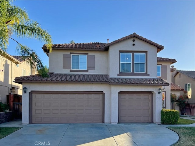 view of front of property featuring an attached garage, driveway, and stucco siding