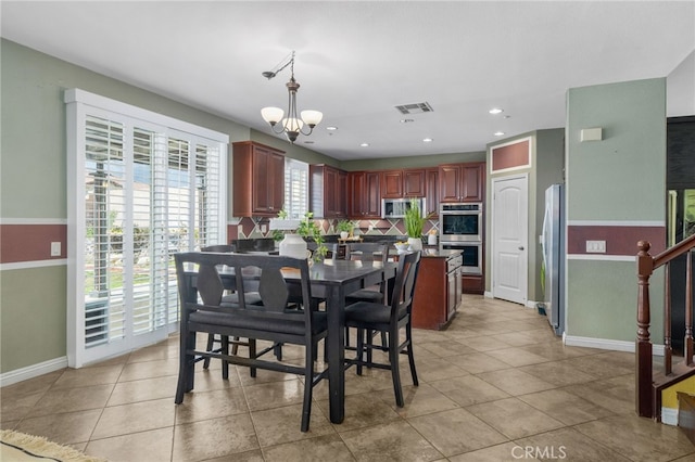 dining space featuring a notable chandelier, light tile patterned floors, recessed lighting, visible vents, and stairs