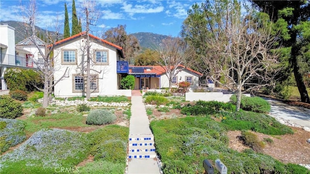 mediterranean / spanish house featuring a mountain view and stucco siding