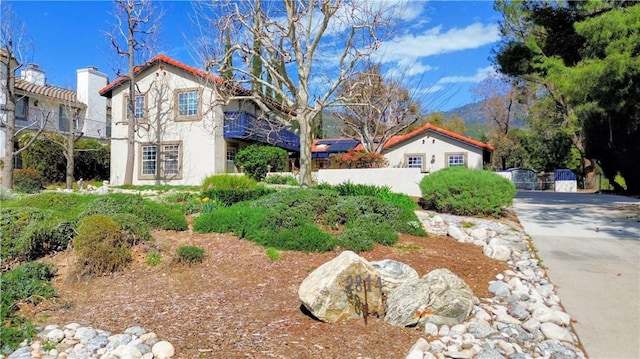 view of home's exterior with fence and stucco siding