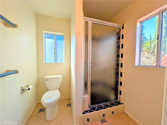 bathroom featuring a stall shower, tile patterned flooring, and plenty of natural light