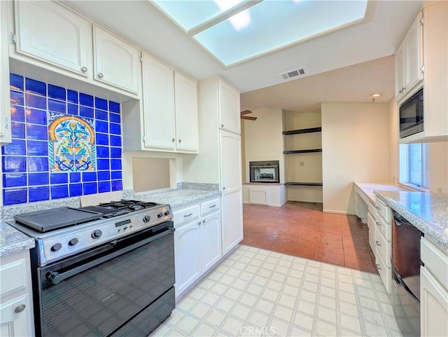 kitchen with dishwashing machine, white cabinetry, visible vents, stainless steel range with gas cooktop, and built in microwave