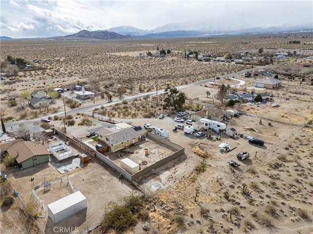 drone / aerial view featuring a mountain view and a desert view