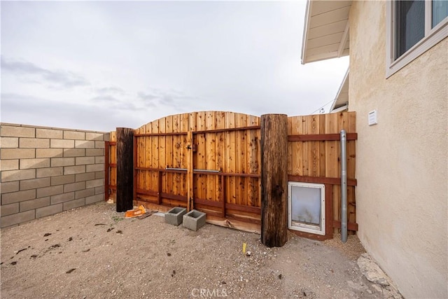 view of gate featuring a fenced backyard