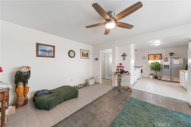 interior space featuring light tile patterned floors and a ceiling fan