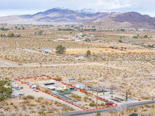 drone / aerial view with view of desert, a rural view, and a mountain view