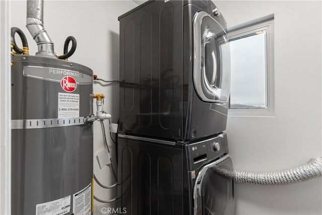 washroom with secured water heater, laundry area, and stacked washing maching and dryer