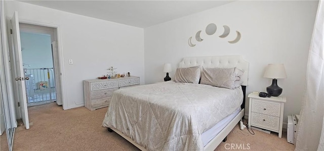 bedroom featuring light colored carpet