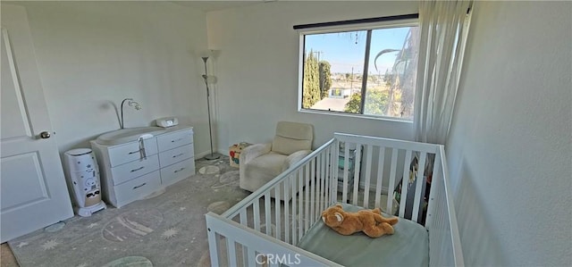 bedroom featuring a nursery area