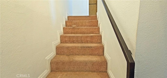 staircase with a textured wall