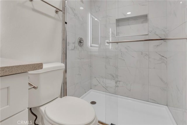 full bathroom with toilet, a shower stall, and vanity