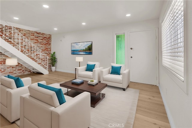 living room with recessed lighting, brick wall, light wood-type flooring, baseboards, and stairs