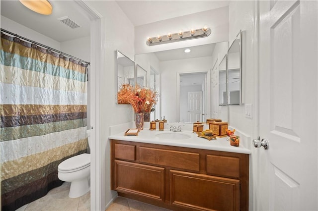 bathroom featuring visible vents, toilet, a shower with curtain, tile patterned floors, and vanity