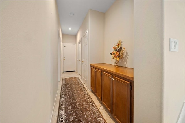 corridor with light tile patterned flooring