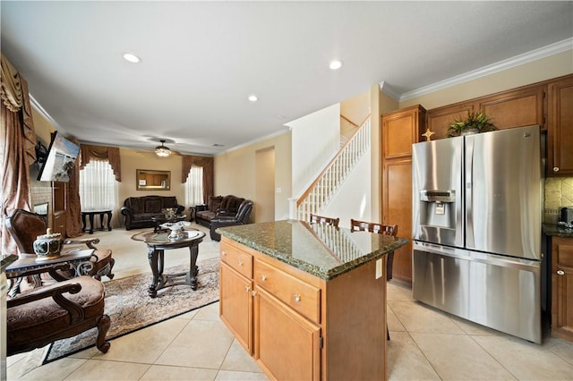 kitchen featuring light tile patterned floors, ornamental molding, and stainless steel fridge with ice dispenser