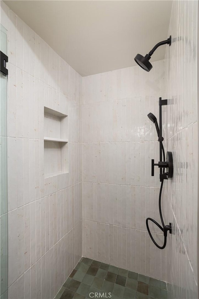 full bath with a tile shower