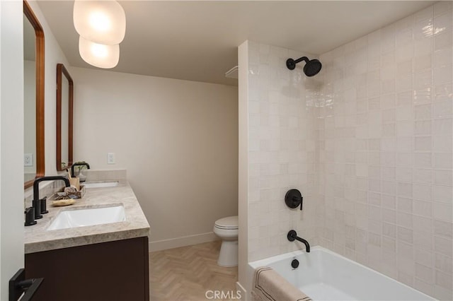 full bathroom with double vanity, shower / bathing tub combination, a sink, and toilet