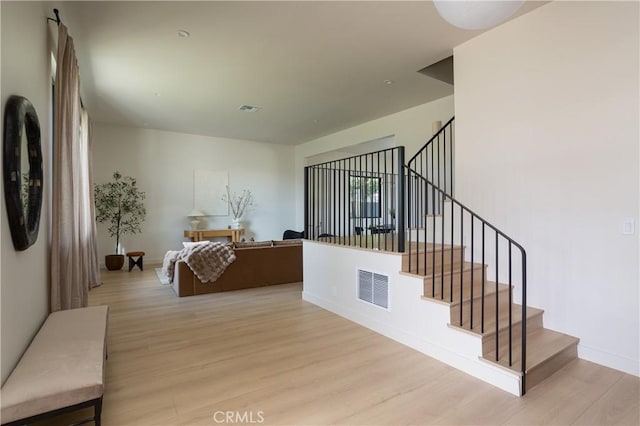 interior space featuring baseboards, visible vents, and wood finished floors