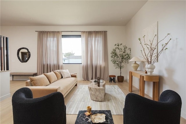 living area featuring light wood-style floors and baseboards