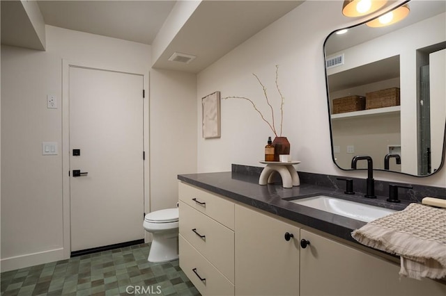 bathroom featuring visible vents, vanity, toilet, and tile patterned floors