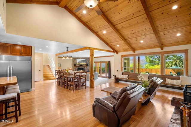 living room with high vaulted ceiling, beamed ceiling, wooden ceiling, and light wood-style flooring