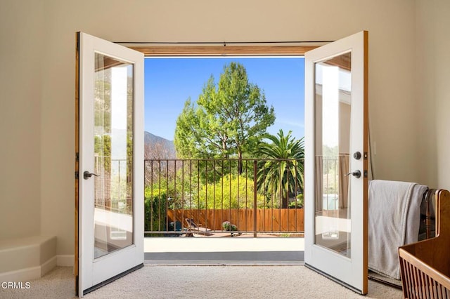 entryway featuring speckled floor, french doors, and a mountain view