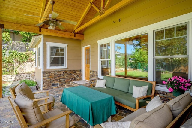 view of patio featuring a ceiling fan, outdoor lounge area, and fence